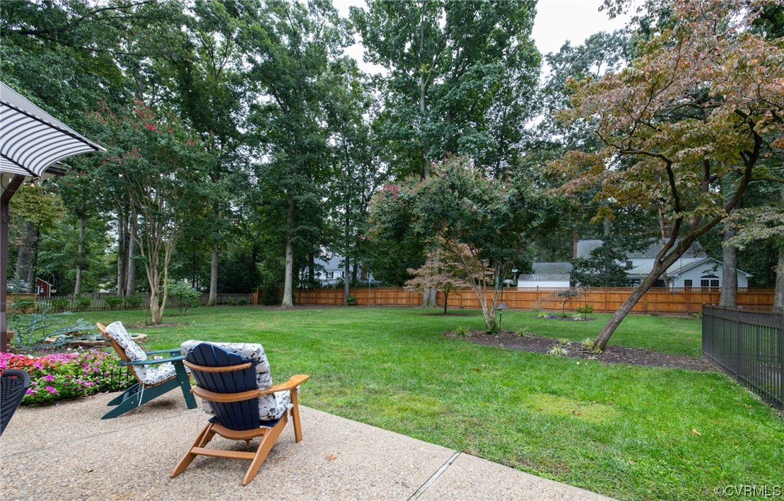 2730 West Brigstock Road Midlothian, VA 23113 - Photo 37 of 49 a view of a backyard with table and chairs and a tree