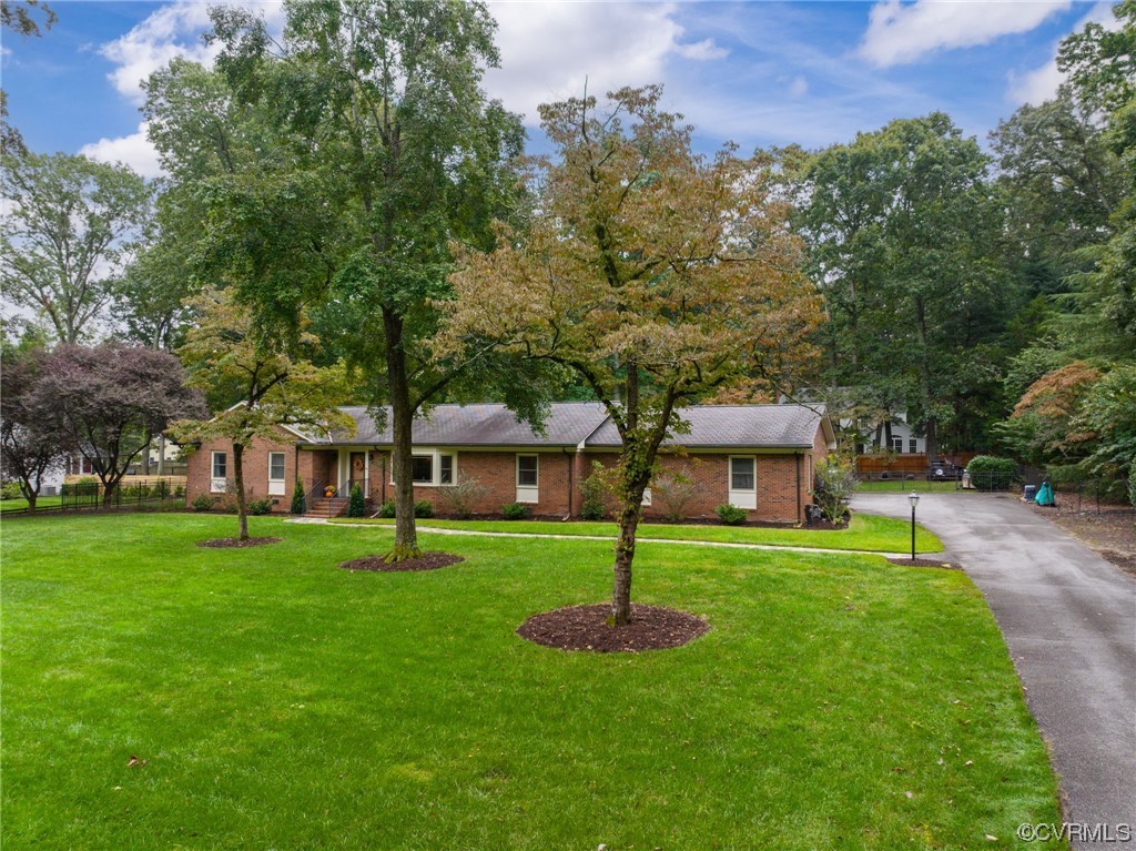 2730 West Brigstock Road Midlothian, VA 23113 - Photo 42 of 49 a front view of a house with a garden
