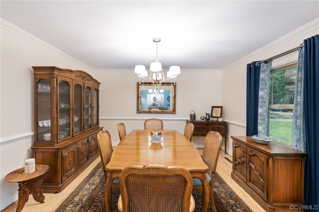 2730 West Brigstock Road Midlothian, VA 23113 - Photo 6 of 49 a view of a dining room with furniture a chandelier and large windows