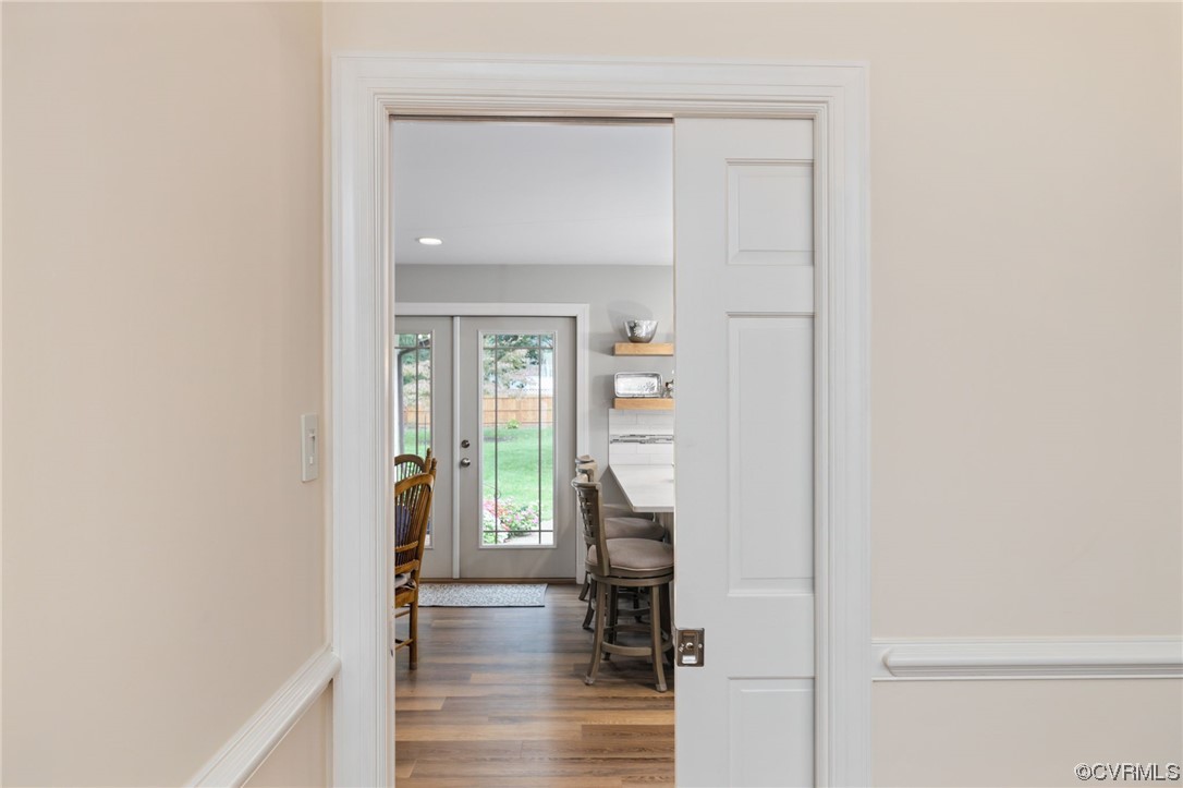 2730 West Brigstock Road Midlothian, VA 23113 - Photo 8 of 49 a view of a hallway with wooden floor and a dining room