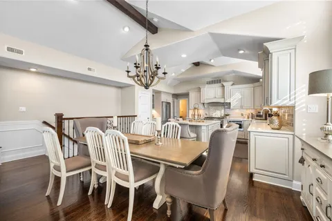 a dining room with furniture and chandelier