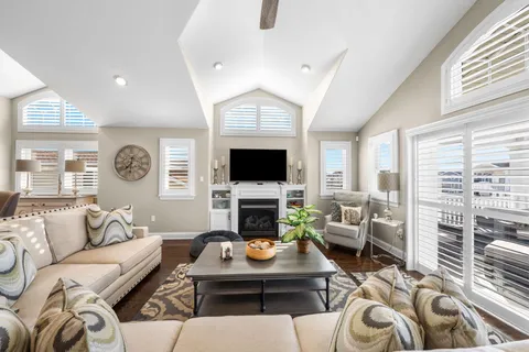 a living room with furniture a fireplace and a flat screen tv