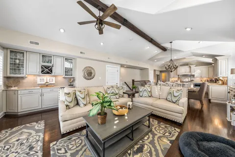 a living room with furniture and a view of kitchen