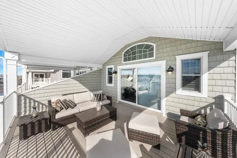 a view of a patio with couches table and chairs and potted plants