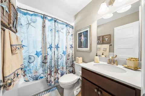 a bathroom with a sink vanity mirror and toilet