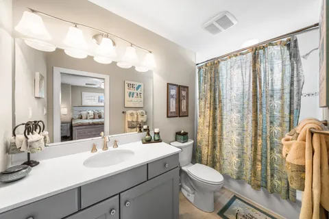a bathroom with a sink vanity mirror and toilet