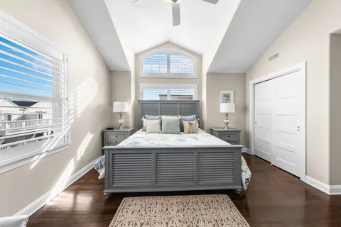 a bedroom with a large bed and a chandelier