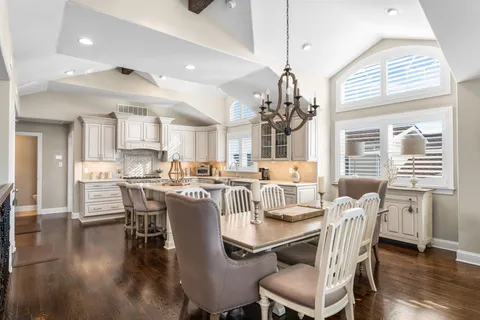 a view of a dining room with furniture wooden floor and chandelier