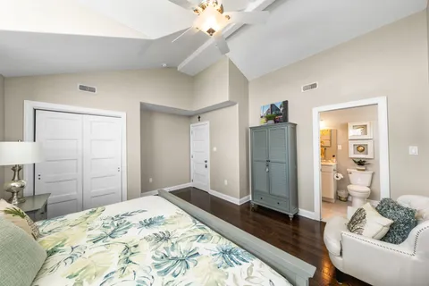 a bedroom with a bed and a dresser in it