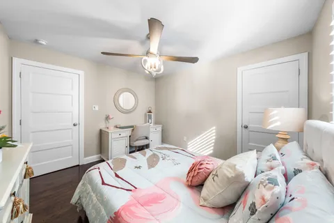 a bedroom with a bed and a chandelier