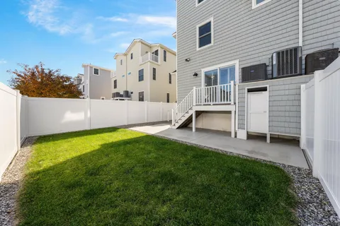 a view of a house with backyard and sitting area
