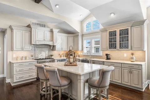 a kitchen with stainless steel appliances granite countertop a sink and cabinets