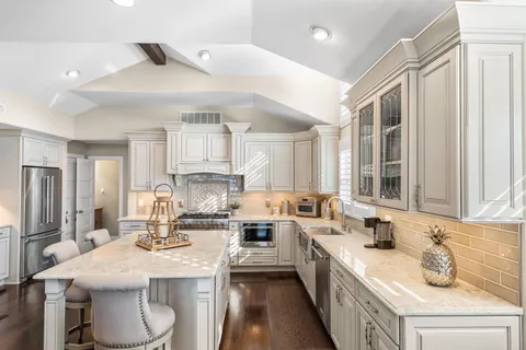 a kitchen with a sink stove and refrigerator
