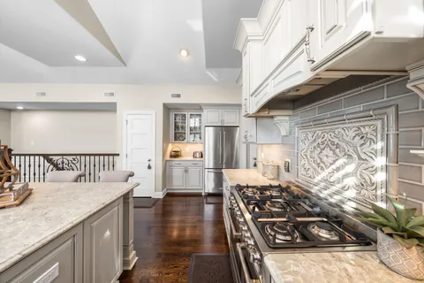 a kitchen with stainless steel appliances granite countertop a stove a sink dishwasher and cabinets