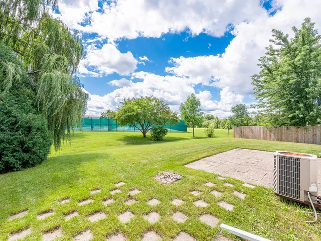 a view of yard with swimming pool and green space