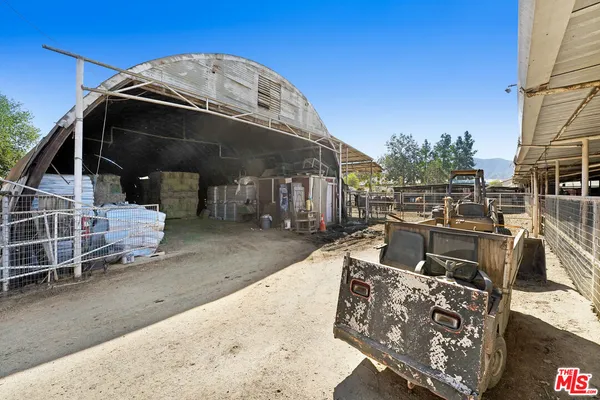 a view of a two chair and table in the backyard