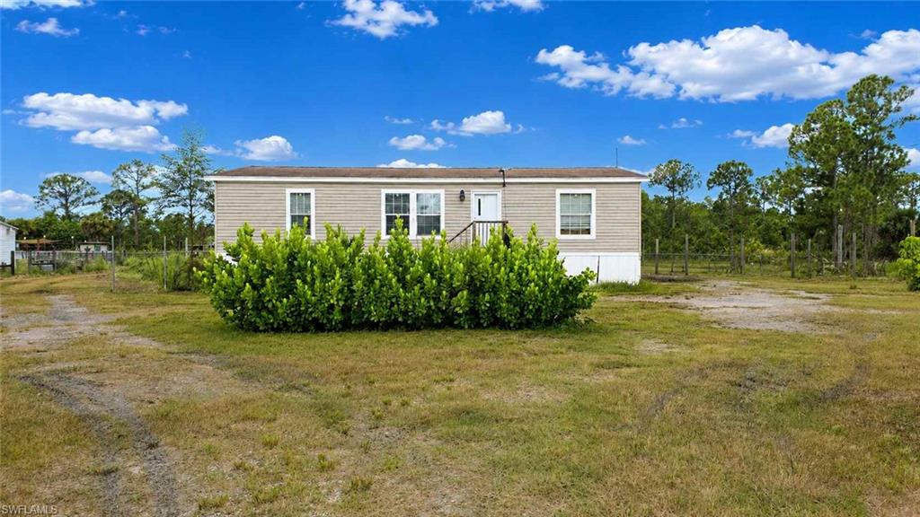 612 Hunting Clb Avenue Montura Ranches, FL 33440 - Photo 5 of 49 a front view of a house with garden