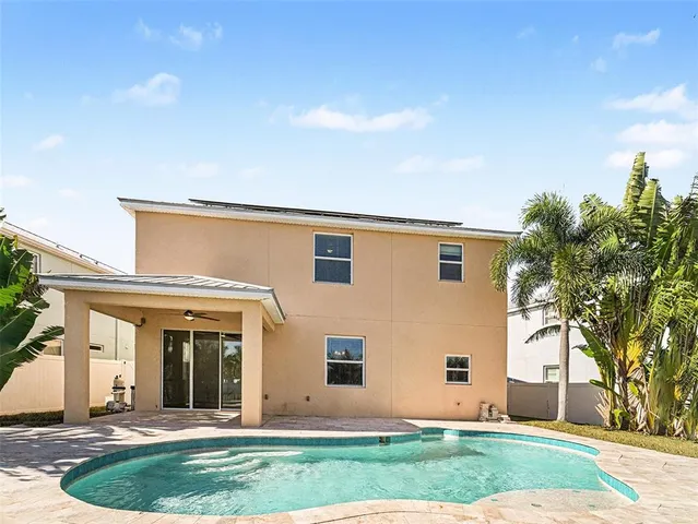 a view of a swimming pool with an outdoor seating