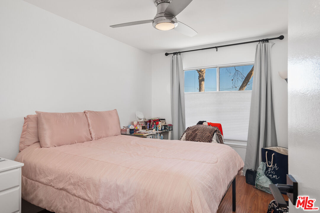 1397 Sycamore Drive Simi Valley, CA 93065 - Photo 13 of 20 a bedroom with a bed and a chandelier