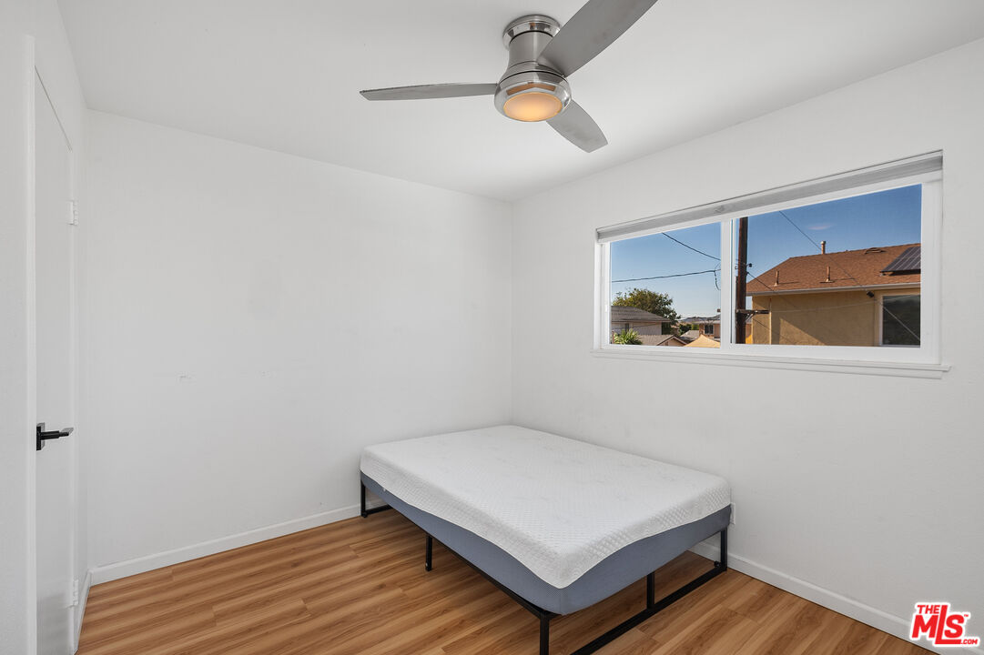 1397 Sycamore Drive Simi Valley, CA 93065 - Photo 17 of 20 a room with wooden floor and ceiling fan