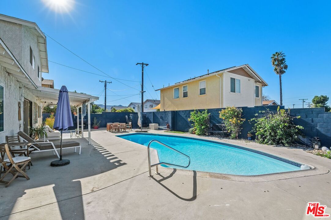 1397 Sycamore Drive Simi Valley, CA 93065 - Photo 20 of 20 a view of a house with swimming pool and sitting area