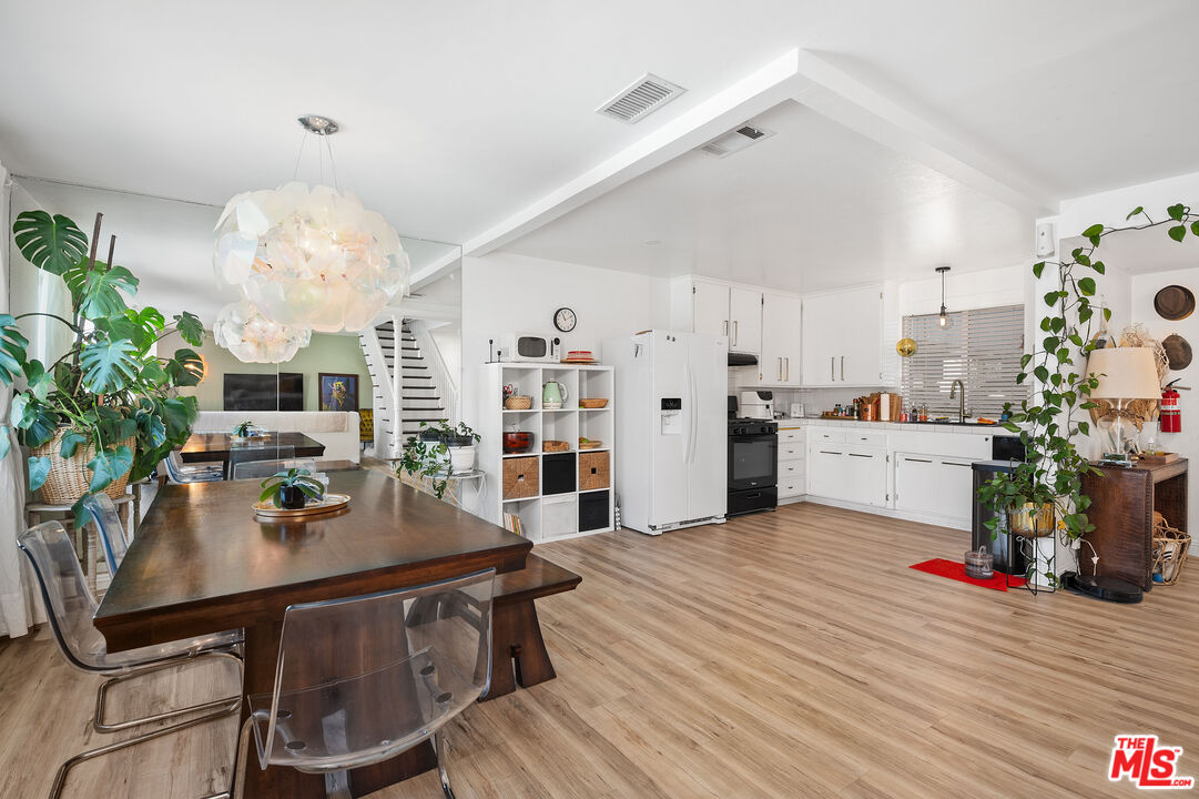 1397 Sycamore Drive Simi Valley, CA 93065 - Photo 5 of 20 a kitchen with a table and chairs in it