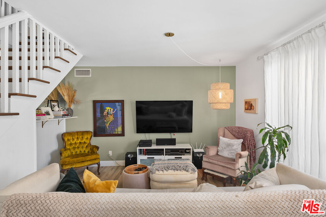 1397 Sycamore Drive Simi Valley, CA 93065 - Photo 8 of 20 a living room with furniture and a flat screen tv