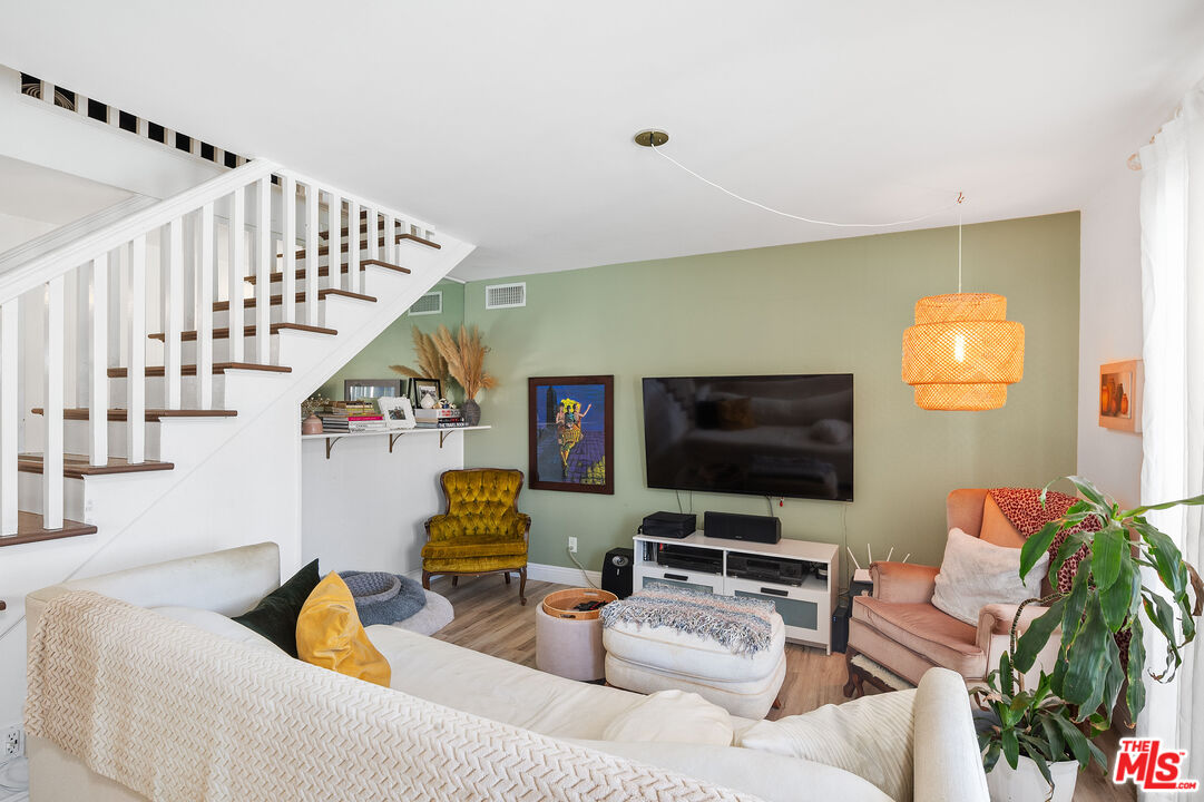1397 Sycamore Drive Simi Valley, CA 93065 - Photo 9 of 20 a living room with furniture and a flat screen tv