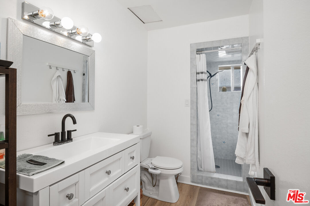 1397 Sycamore Drive Simi Valley, CA 93065 - Photo 10 of 20 a bathroom with a toilet sink and shower