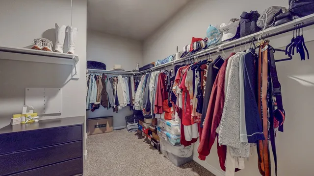 a view of walk in closet with clothes