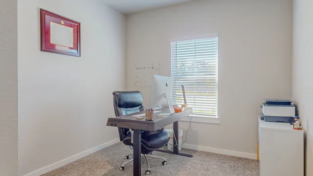 an empty room with furniture and air conditioner vent