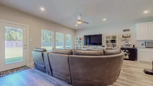 a dining room with furniture and wooden floor