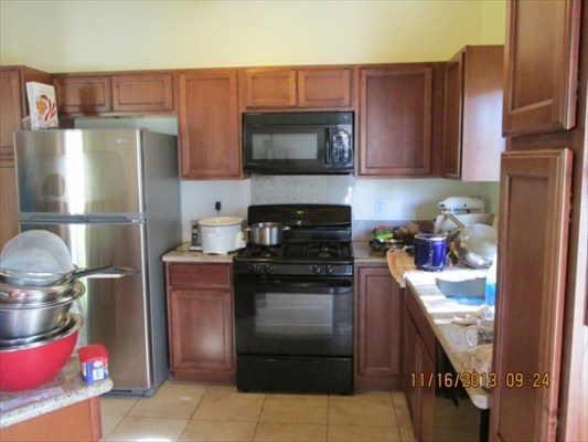 18-7892 Kini Road Mountain View, HI 96771 - Photo 8 of 22 a kitchen with a stove and a refrigerator