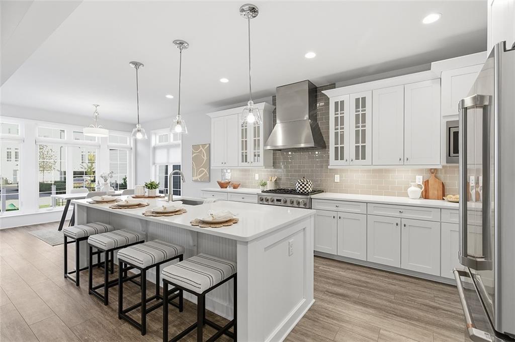 3061 Preston Way Bridgeville, PA 15017 - Photo 17 of 45 a kitchen with stainless steel appliances granite countertop a sink a stove a refrigerator and island with wooden floor