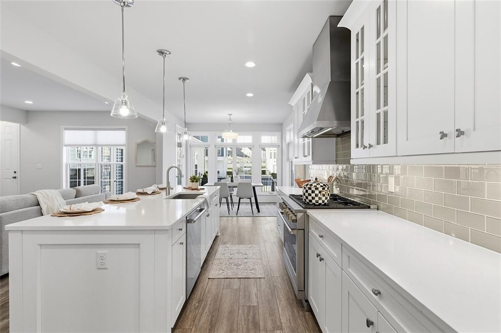 3061 Preston Way Bridgeville, PA 15017 - Photo 19 of 45 a kitchen with stainless steel appliances granite countertop a sink a stove and a wooden floors