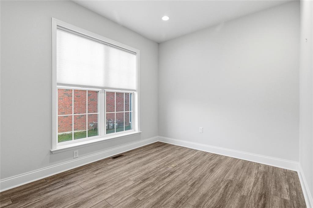3061 Preston Way Bridgeville, PA 15017 - Photo 42 of 45 an empty room with wooden floor and windows