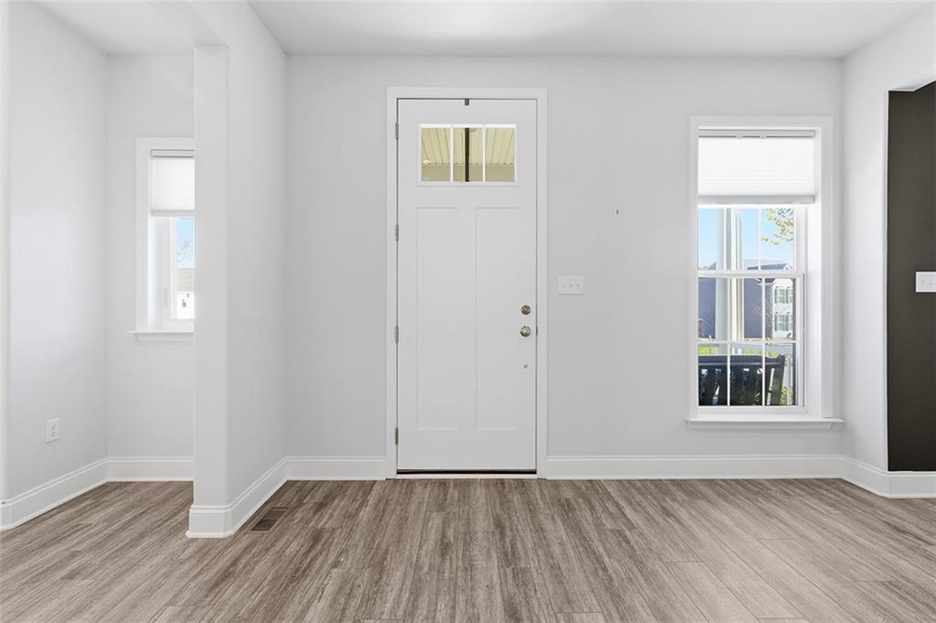 3061 Preston Way Bridgeville, PA 15017 - Photo 9 of 45 an empty room with wooden floor and windows