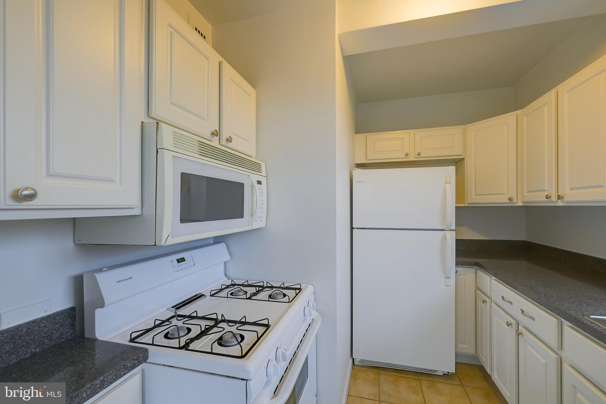 3601 Wisconsin Avenue Northwest, Unit 504 Washington, DC 20016 - Photo 14 of 23 a kitchen with a stove and a microwave