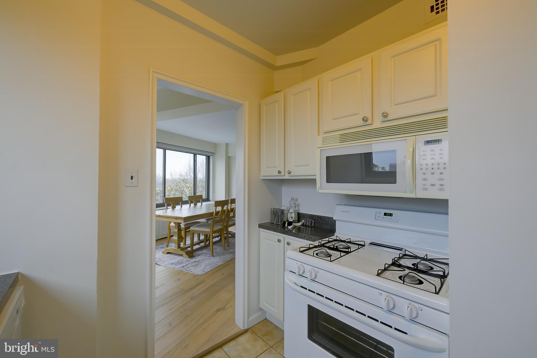 3601 Wisconsin Avenue Northwest, Unit 504 Washington, DC 20016 - Photo 16 of 23 a kitchen with white cabinets and appliances