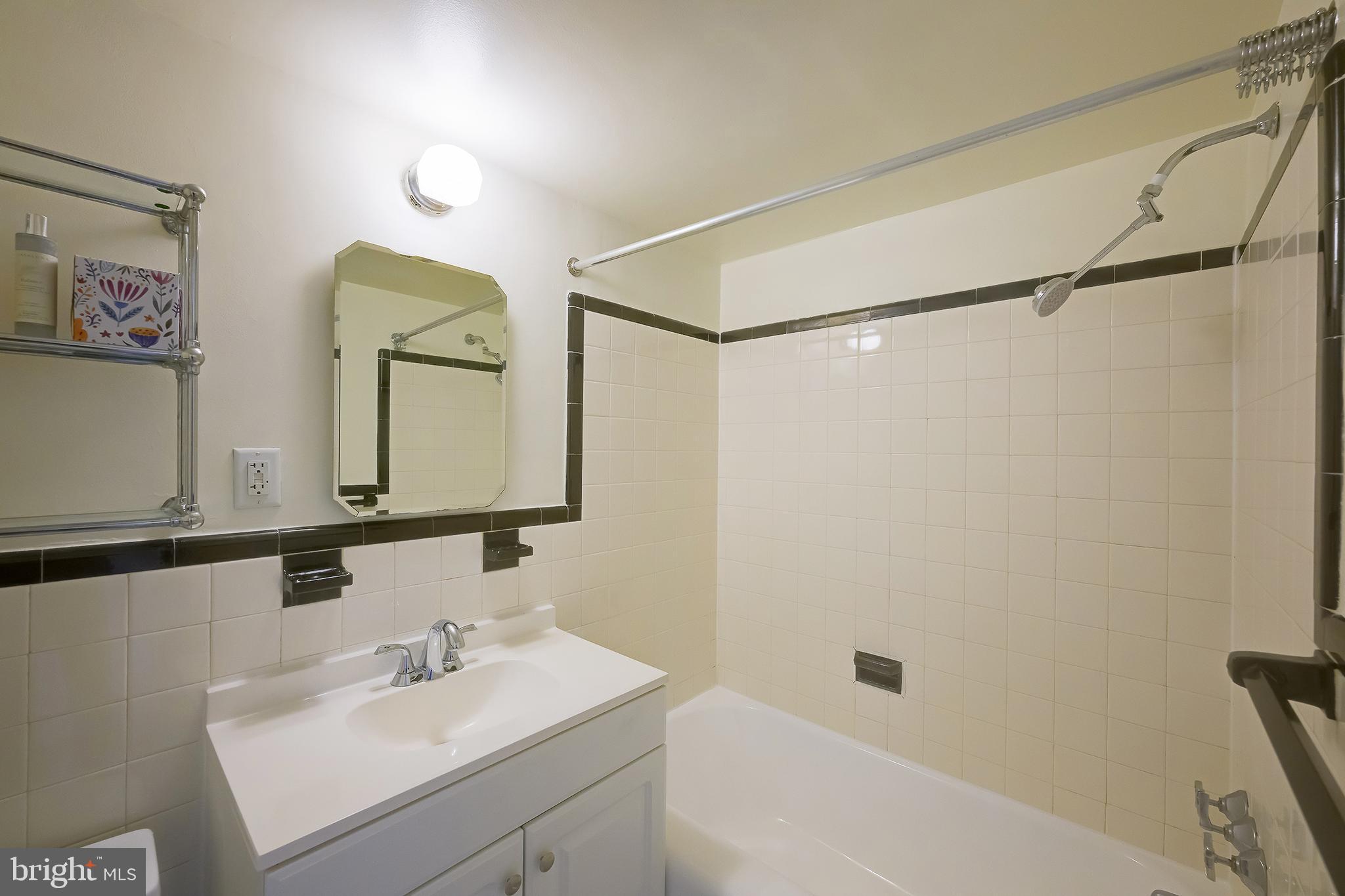 3601 Wisconsin Avenue Northwest, Unit 504 Washington, DC 20016 - Photo 17 of 23 a bathroom with a sink mirror and a shower