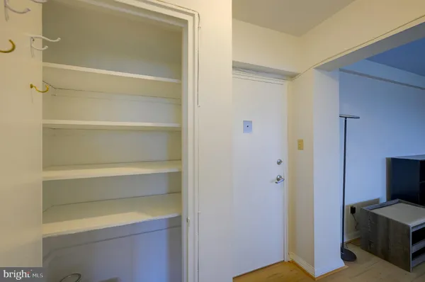 a bedroom with a bed a window and closet