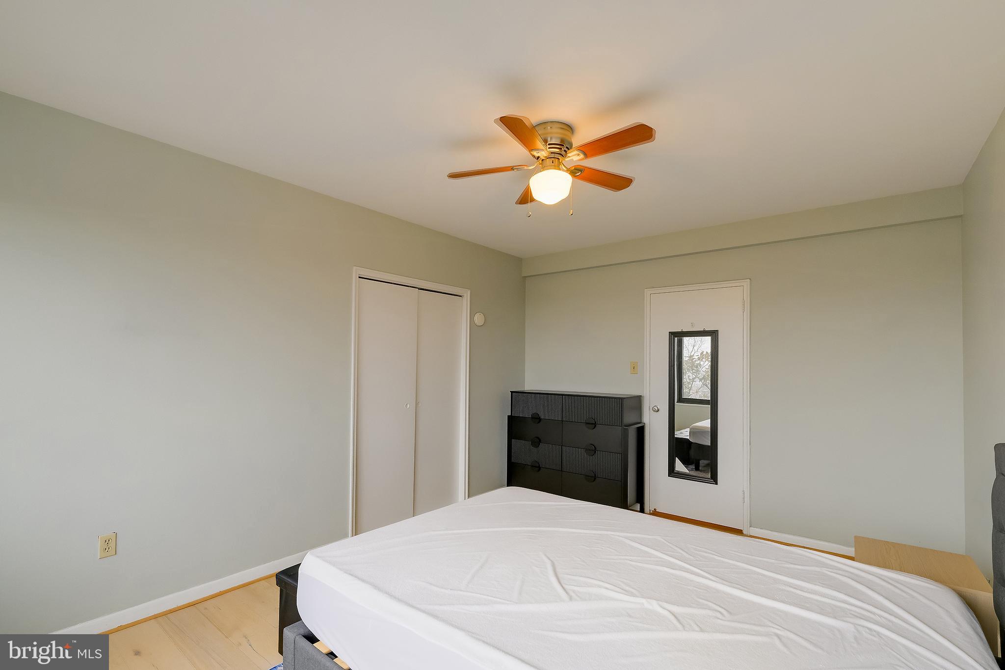 3601 Wisconsin Avenue Northwest, Unit 504 Washington, DC 20016 - Photo 22 of 23 a bedroom with a bed and a chandelier