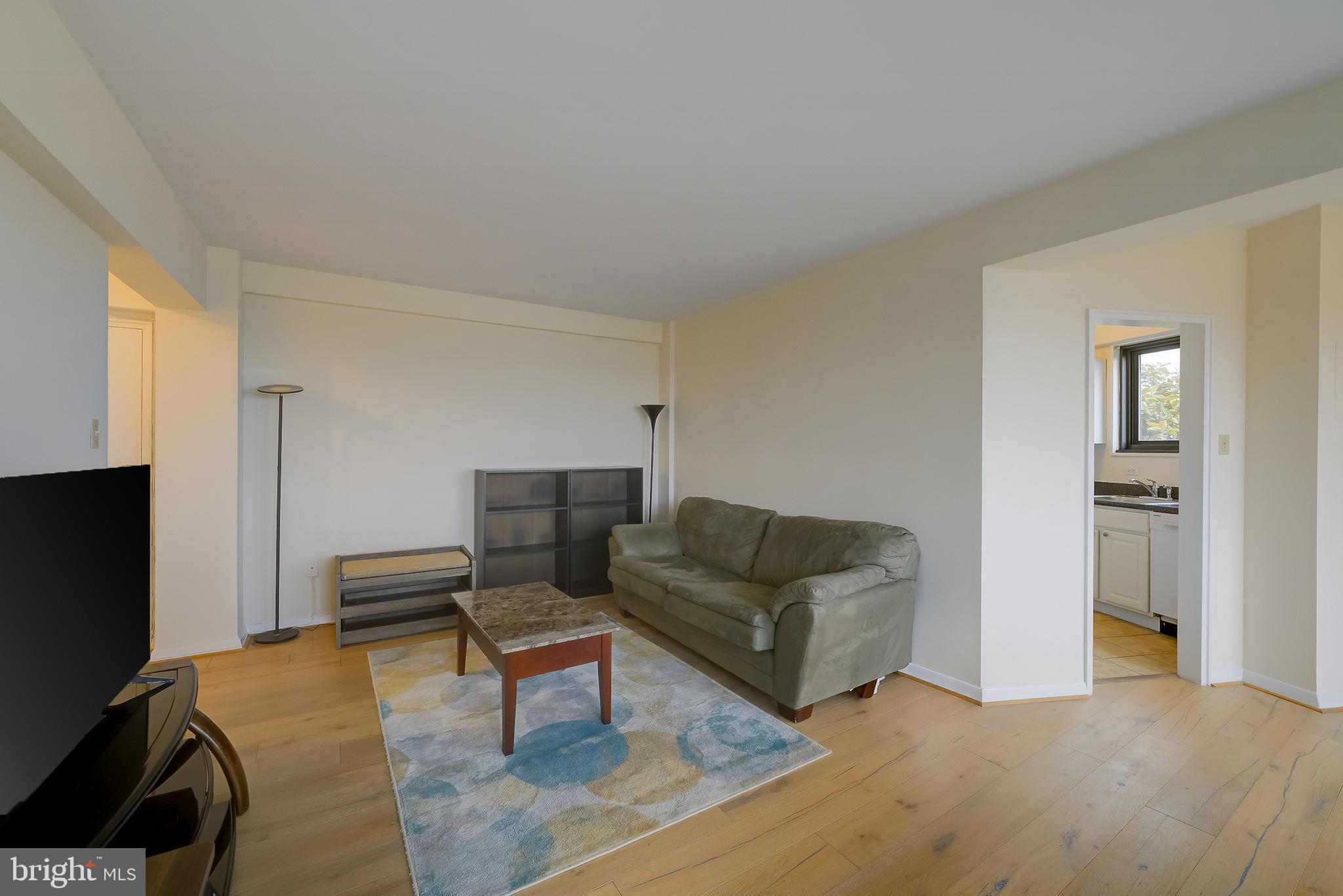 3601 Wisconsin Avenue Northwest, Unit 504 Washington, DC 20016 - Photo 5 of 23 a living room with furniture a flat screen tv and a couch