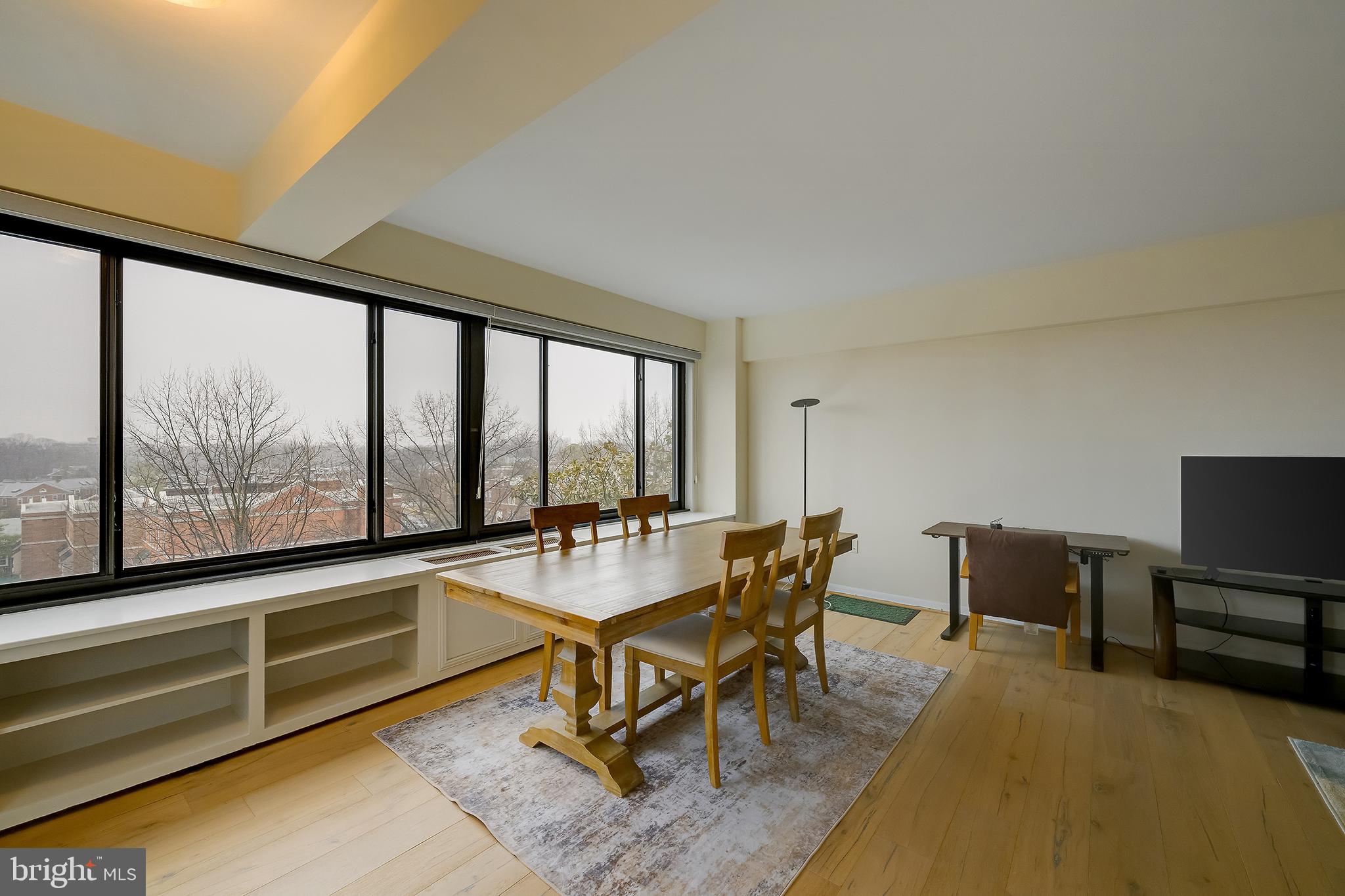 3601 Wisconsin Avenue Northwest, Unit 504 Washington, DC 20016 - Photo 9 of 23 a dining room with furniture and a floor to ceiling window