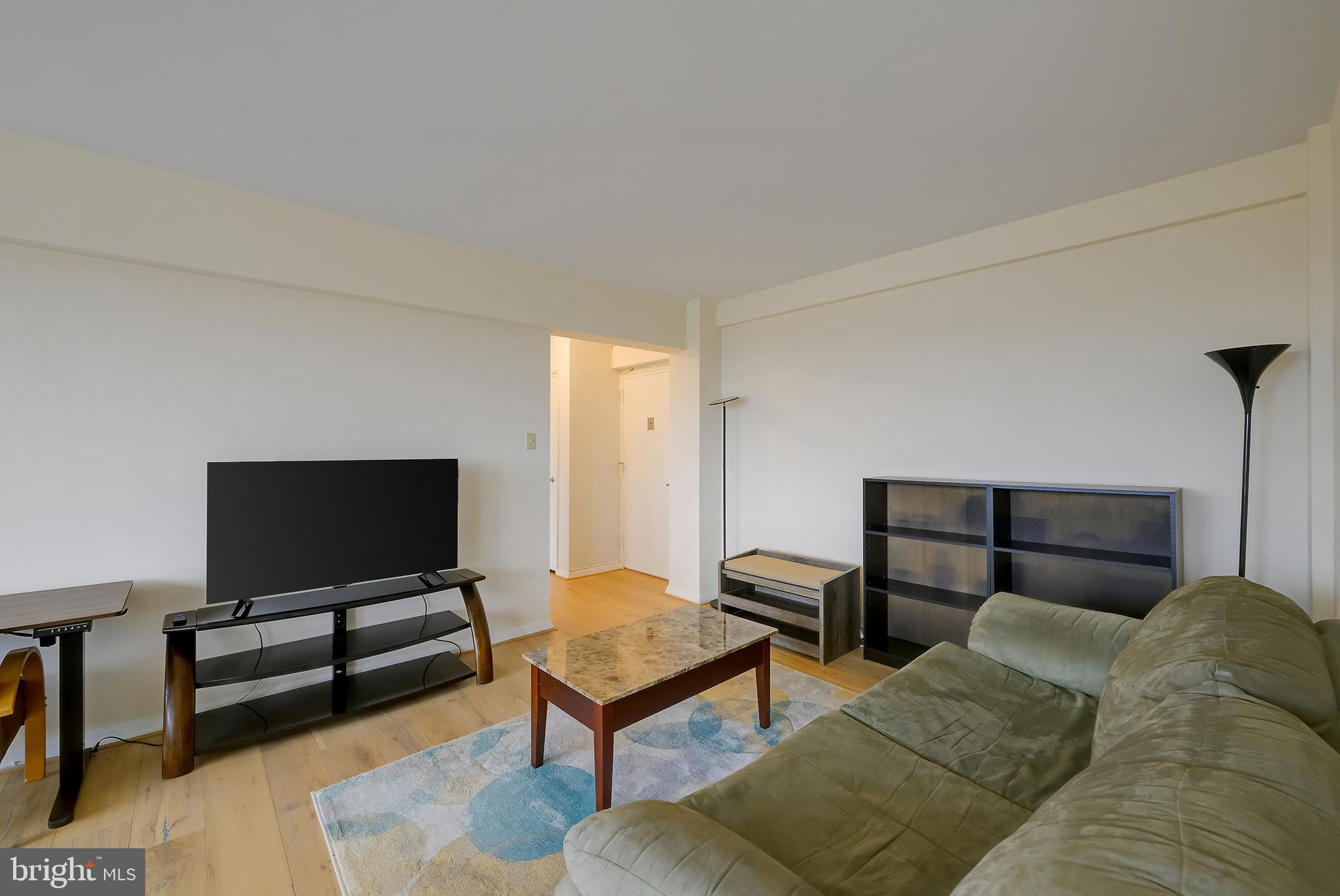 3601 Wisconsin Avenue Northwest, Unit 504 Washington, DC 20016 - Photo 10 of 23 a living room with furniture and a flat screen tv