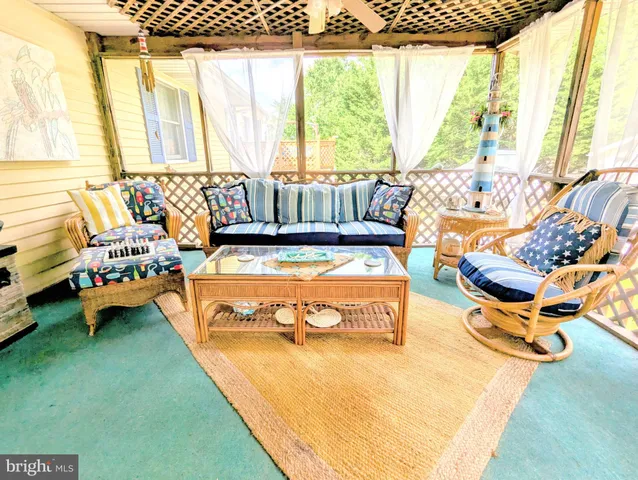a view of a backyard with couches under an umbrella