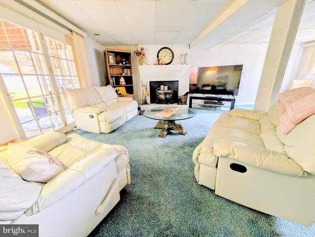 a living room with furniture and a lamp