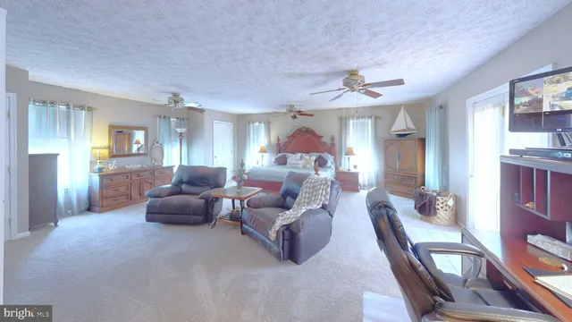 a living room with furniture a large window and a fireplace
