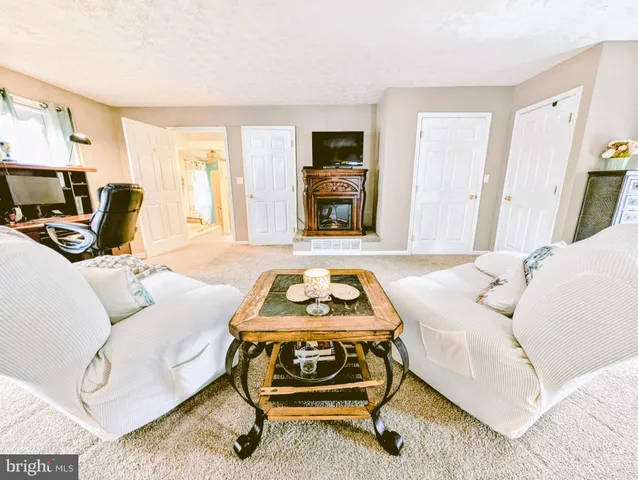 a view of a backyard with table and chairs potted plants and wooden fence