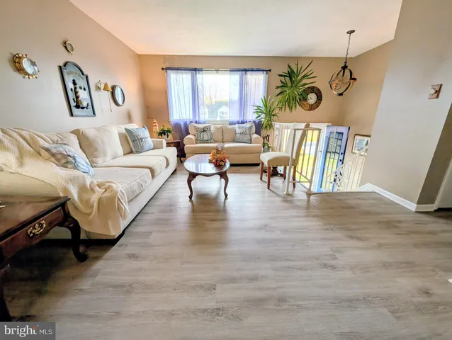 a view of a dining room with furniture and a large window